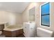 Bathroom featuring a jetted tub and a modern vanity with good natural light at 351 Hemlock Ln, Locust Grove, GA 30248