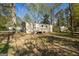 A manufactured home with a wooden deck and stairs in a wooded area at 351 Hemlock Ln, Locust Grove, GA 30248