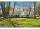 Charming single-story home with white picket fence and mature trees in a lush green yard at 351 Hemlock Ln, Locust Grove, GA 30248