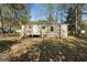 Exterior shot of the home's front side and yard surrounded by trees at 351 Hemlock Ln, Locust Grove, GA 30248