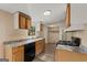 Well-lit kitchen showcasing wooden cabinets, black appliances, and attractive flooring at 351 Hemlock Ln, Locust Grove, GA 30248