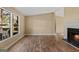 Bright living room with large windows, a fireplace, and attractive, wood-look floors at 351 Hemlock Ln, Locust Grove, GA 30248