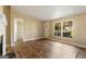 Inviting living room with wood-look floors, large windows, and neutral-toned walls at 351 Hemlock Ln, Locust Grove, GA 30248