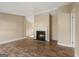 Cozy living room featuring a fireplace and stylish, wood-look laminate flooring at 351 Hemlock Ln, Locust Grove, GA 30248