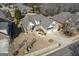 Expansive aerial view of brick and siding home with mature landscaping and a three-car garage at 409 Brandy Ln, Mcdonough, GA 30253