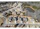 Aerial view of a neighborhood with a mix of houses, streets, and some trees, next to a pond at 409 Brandy Ln, Mcdonough, GA 30253