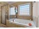 Relaxing bathroom featuring a soaking tub and glass-enclosed shower at 409 Brandy Ln, Mcdonough, GA 30253