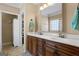 Bathroom featuring a double vanity, wood cabinets, and ample lighting at 409 Brandy Ln, Mcdonough, GA 30253