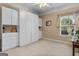 Bright bedroom with built-in storage cabinets and large window offering plenty of natural light at 409 Brandy Ln, Mcdonough, GA 30253