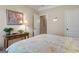 Inviting bedroom with a decorative floral quilt, side table and art work at 409 Brandy Ln, Mcdonough, GA 30253