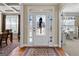 Inviting foyer features a decorative glass front door and hardwood floors at 409 Brandy Ln, Mcdonough, GA 30253