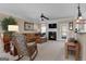 Cozy living room with fireplace, ceiling fan, and comfortable seating at 409 Brandy Ln, Mcdonough, GA 30253