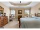 Serene main bedroom featuring a tray ceiling and natural light at 409 Brandy Ln, Mcdonough, GA 30253