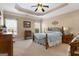 Comfortable primary bedroom with neutral colors, a tray ceiling, and large windows at 409 Brandy Ln, Mcdonough, GA 30253