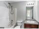 Well-lit bathroom featuring a shower-tub combo and granite countertop vanity at 540 Hamlet Dr, Hampton, GA 30228