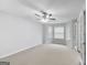 Spacious bedroom with large windows, carpet floors, and a ceiling fan at 540 Hamlet Dr, Hampton, GA 30228