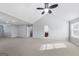 Spacious bedroom featuring a ceiling fan, neutral paint and carpet, and a large entryway at 540 Hamlet Dr, Hampton, GA 30228