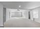 Large bedroom features neutral paint and carpet, a ceiling fan, and two windows at 540 Hamlet Dr, Hampton, GA 30228