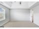 Bedroom featuring neutral paint and carpet, a tray ceiling, and a window at 540 Hamlet Dr, Hampton, GA 30228