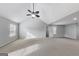 Spacious bedroom featuring a ceiling fan, neutral paint and carpet, and a large window at 540 Hamlet Dr, Hampton, GA 30228