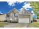 Charming two-story home with brick facade, blue shutters, and attached two car garage at 540 Hamlet Dr, Hampton, GA 30228