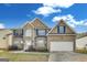 Charming two-story home with brick facade, blue shutters, and well-manicured landscaping at 540 Hamlet Dr, Hampton, GA 30228