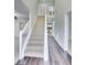 Bright foyer with high ceilings, hardwood floors, staircase with white railing, and open layout at 540 Hamlet Dr, Hampton, GA 30228