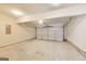 Spacious garage with white garage door, concrete floor, and overhead lighting at 540 Hamlet Dr, Hampton, GA 30228