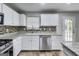 Bright kitchen features stainless appliances, stylish backsplash, and ample counter space at 540 Hamlet Dr, Hampton, GA 30228