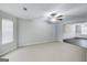 Spacious carpeted living room with a ceiling fan that flows into dining room with hardwood floors at 540 Hamlet Dr, Hampton, GA 30228