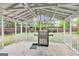 Screened-in porch with grill, metal frame, and concrete flooring at 540 Hamlet Dr, Hampton, GA 30228
