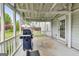 Screened-in porch featuring a grill, grey floor, and access to yard at 540 Hamlet Dr, Hampton, GA 30228