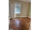 Bedroom featuring hardwood floors, a window, and ample natural light at 4941 Old Atlanta Rd, Hampton, GA 30228