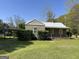 Charming single story home with a metal roof and mature landscaping at 4941 Old Atlanta Rd, Hampton, GA 30228