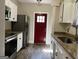 Bright kitchen with stainless steel appliances, granite counters, and updated flooring at 4941 Old Atlanta Rd, Hampton, GA 30228