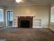 Cozy living room featuring a decorative brick fireplace and built-in bookshelves at 4941 Old Atlanta Rd, Hampton, GA 30228