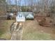Aerial view of a well-maintained single-Gathering home with a long driveway at 1103 Larkspur Dr, Locust Grove, GA 30248