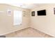 Bedroom with carpet, window, ceiling fan, and decorative wall art at 1103 Larkspur Dr, Locust Grove, GA 30248