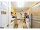 Functional kitchen with tile flooring, wooden cabinets, and stainless steel appliances at 1103 Larkspur Dr, Locust Grove, GA 30248
