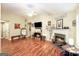 Spacious living room with a fireplace, hardwood floors, a ceiling fan and large windows at 1103 Larkspur Dr, Locust Grove, GA 30248