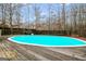 In-ground pool surrounded by a wood deck and privacy fence at 1103 Larkspur Dr, Locust Grove, GA 30248