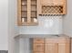 Elegant bar area featuring wooden cabinets, a sink, and a decorative backsplash at 1230 Hayes Sq, Peachtree City, GA 30269