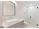 Bathroom featuring a large vanity, modern fixtures, and tiled walk-in shower at 1230 Hayes Sq, Peachtree City, GA 30269