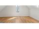 Spacious bedroom with wood floors, angled ceilings and a window allowing for natural light at 1230 Hayes Sq, Peachtree City, GA 30269