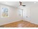 Bright bedroom features wood floors, white trim, ceiling fan and ample natural light at 1230 Hayes Sq, Peachtree City, GA 30269