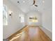 Bright bedroom with hardwood floors and recessed lighting is enhanced by large windows and modern wall sconces at 1230 Hayes Sq, Peachtree City, GA 30269