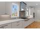 Modern kitchen with white cabinets, stainless steel appliances, and gray backsplash at 1230 Hayes Sq, Peachtree City, GA 30269