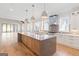 A bright kitchen with a large island, pendant lighting, and stainless steel appliances at 1230 Hayes Sq, Peachtree City, GA 30269