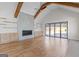 Bright living room boasts hardwood floors, ceiling fan, beams, and a fireplace with built-in cabinets at 1230 Hayes Sq, Peachtree City, GA 30269