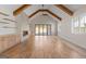 Spacious living room with hardwood floors, a fireplace, and large windows overlooking the backyard at 1230 Hayes Sq, Peachtree City, GA 30269